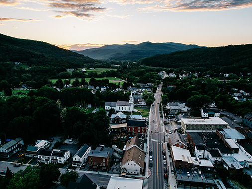 Green mountains and trees are seen from above in Waterbury, VT.