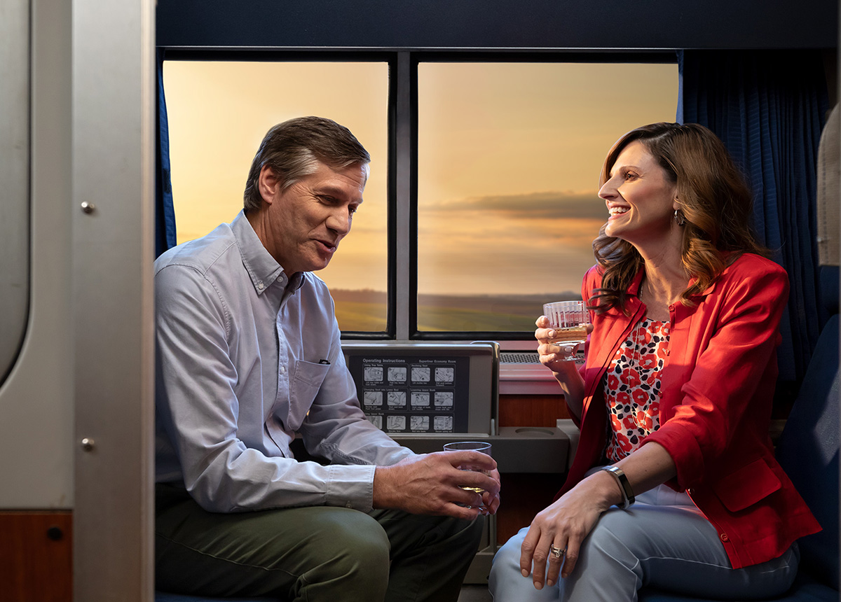 A couple laughs in a train car