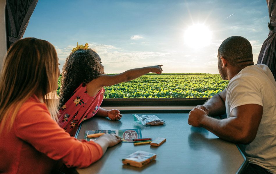 Une famille regarde à travers une fenêtre de train