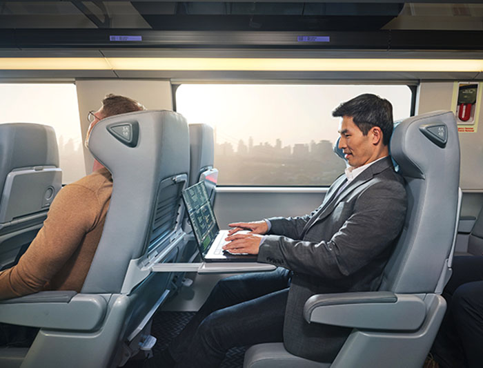 A businessman works on his laptop onboard NextGen Acela in Business Class.