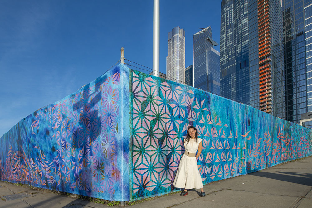 Artist Marisa Morán Jahn stands in front of her art