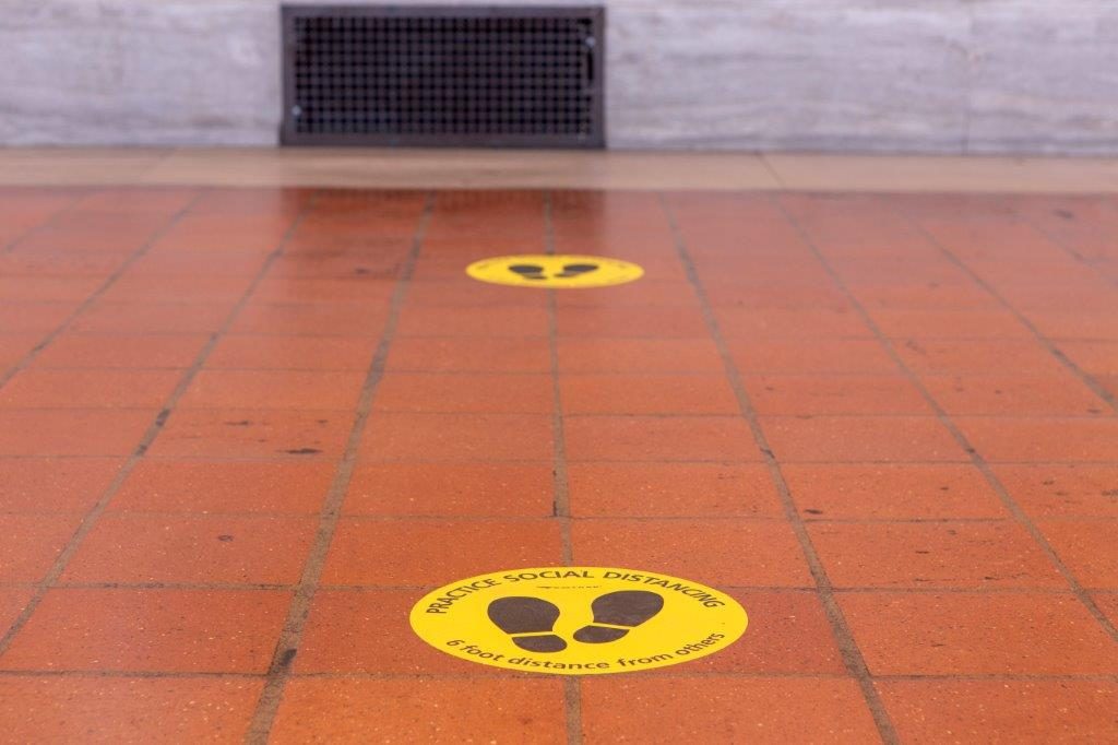 Social distancing floor markers in a station.