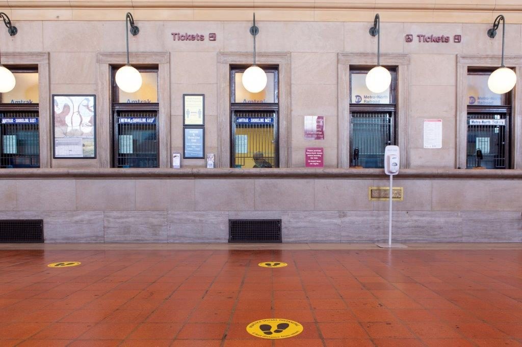 Social distancing floor markers in a station.