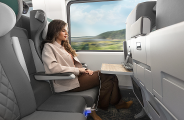 Passenger relaxing in a spacious Amtrak Cascades seat