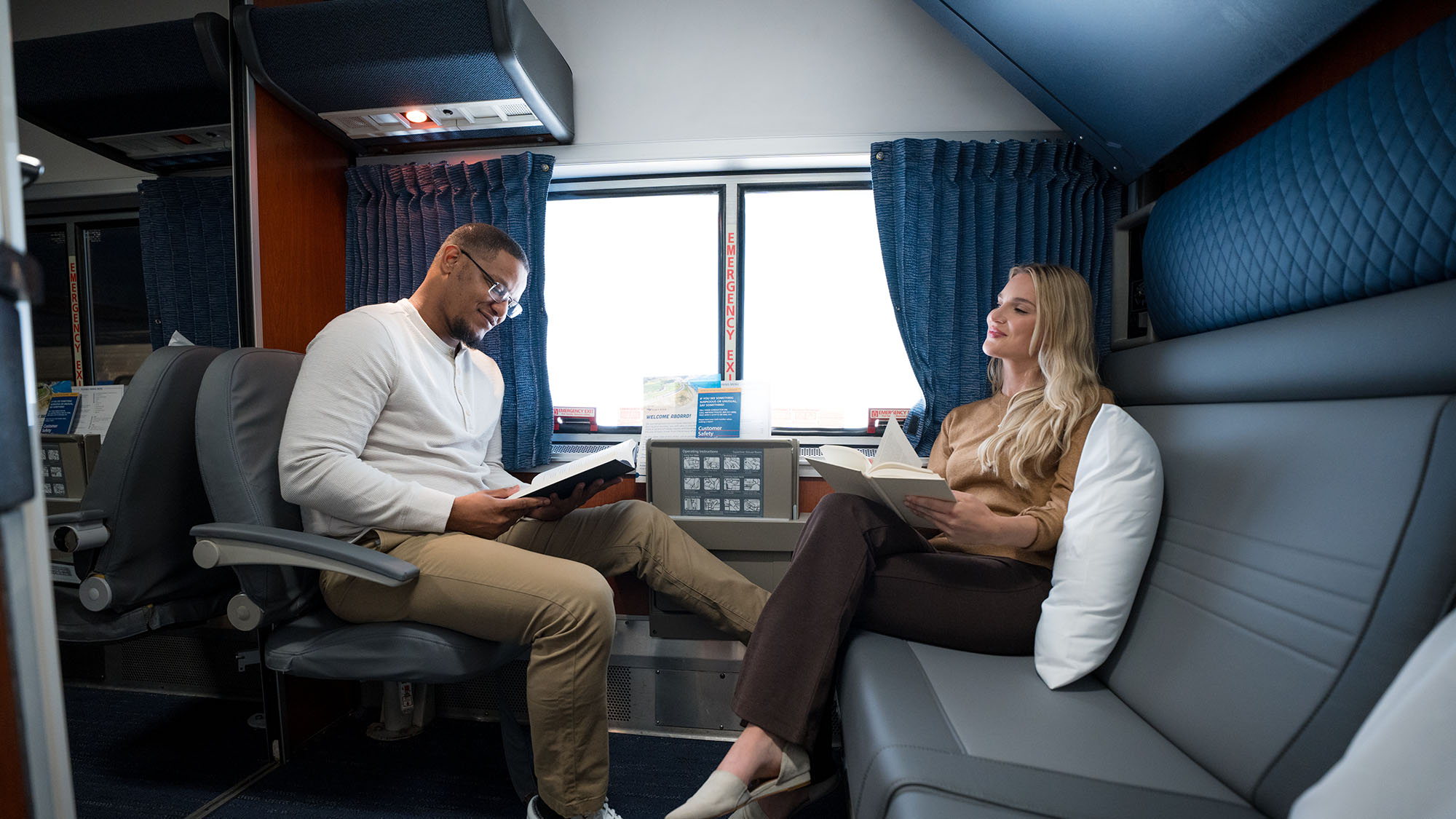 A man and woman read in a bedroom