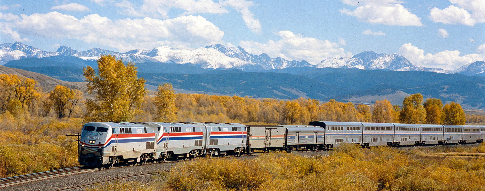 Train in Valley with Scenic Mountains in Background