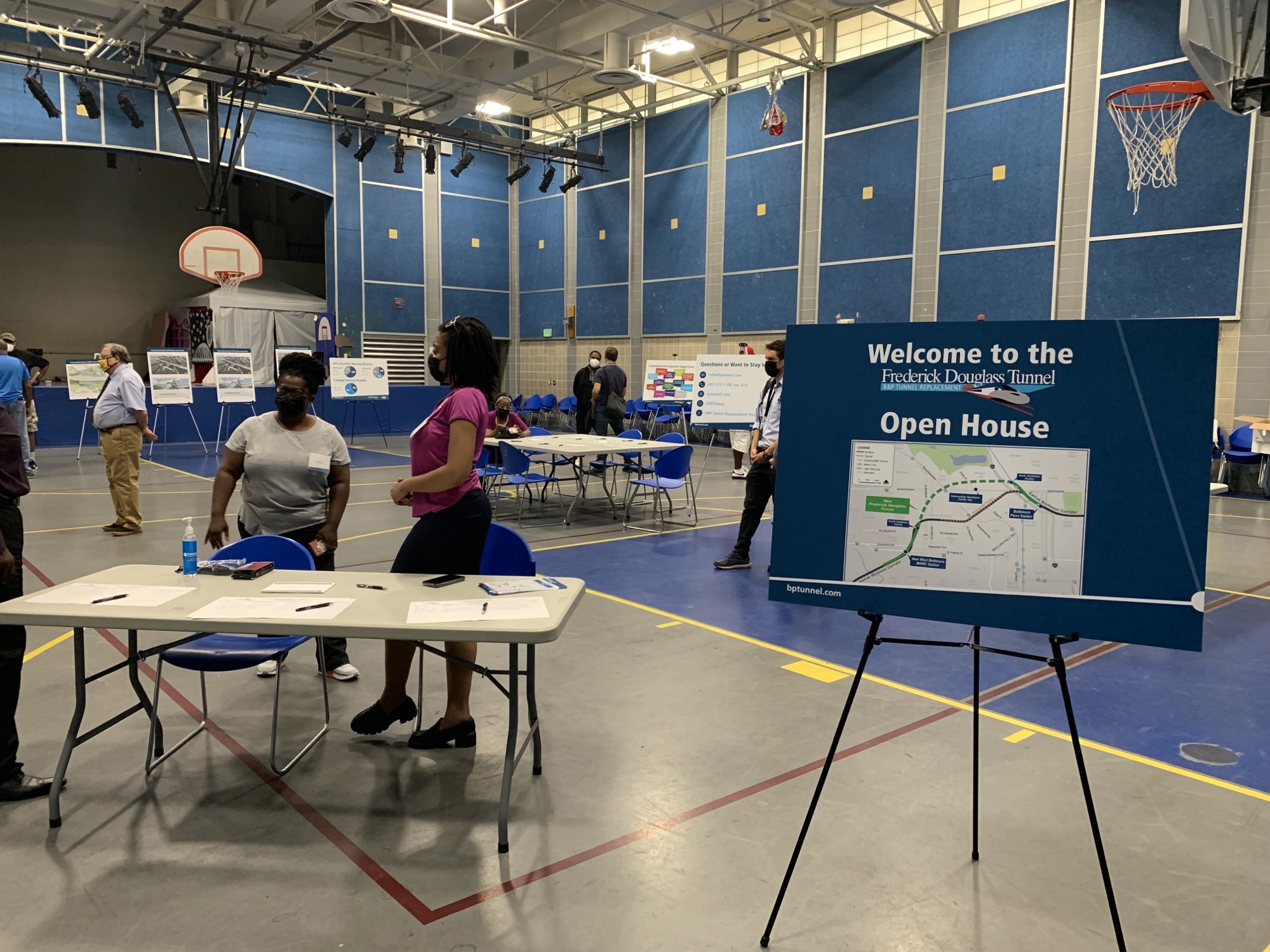 Employees attend a community event in a gymnasium 