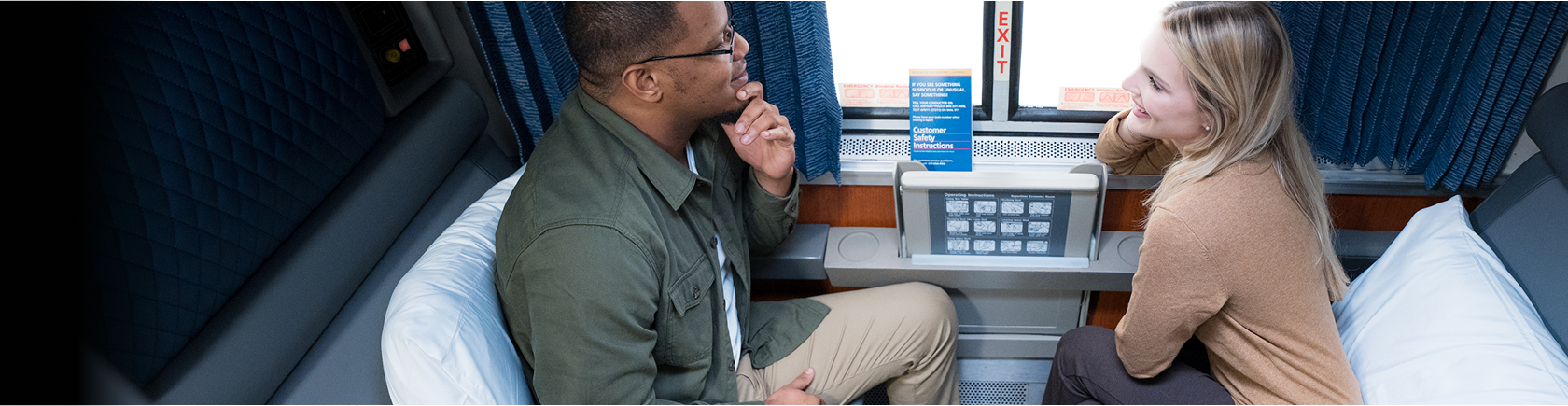 happy-couple-looking-out-window-in-amtrak-roomette