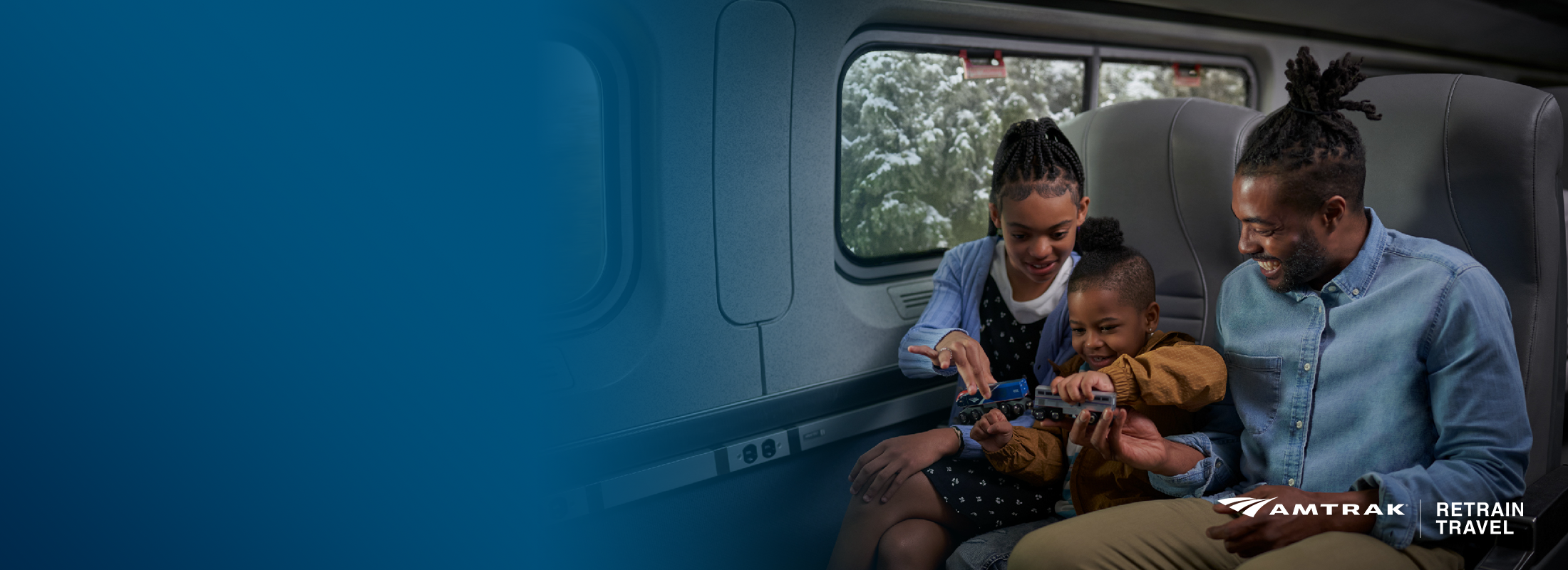 father-with-kids-and-a-toy-train-on-amtrak-during-winter