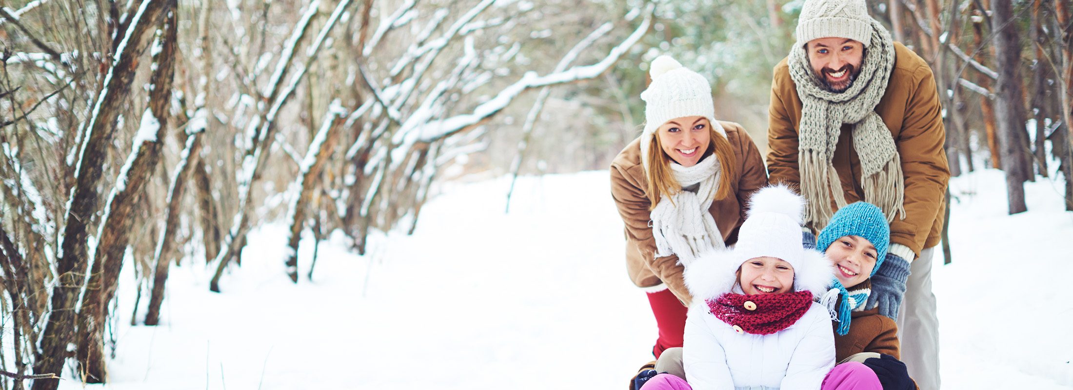 Family playing outdoors in snow