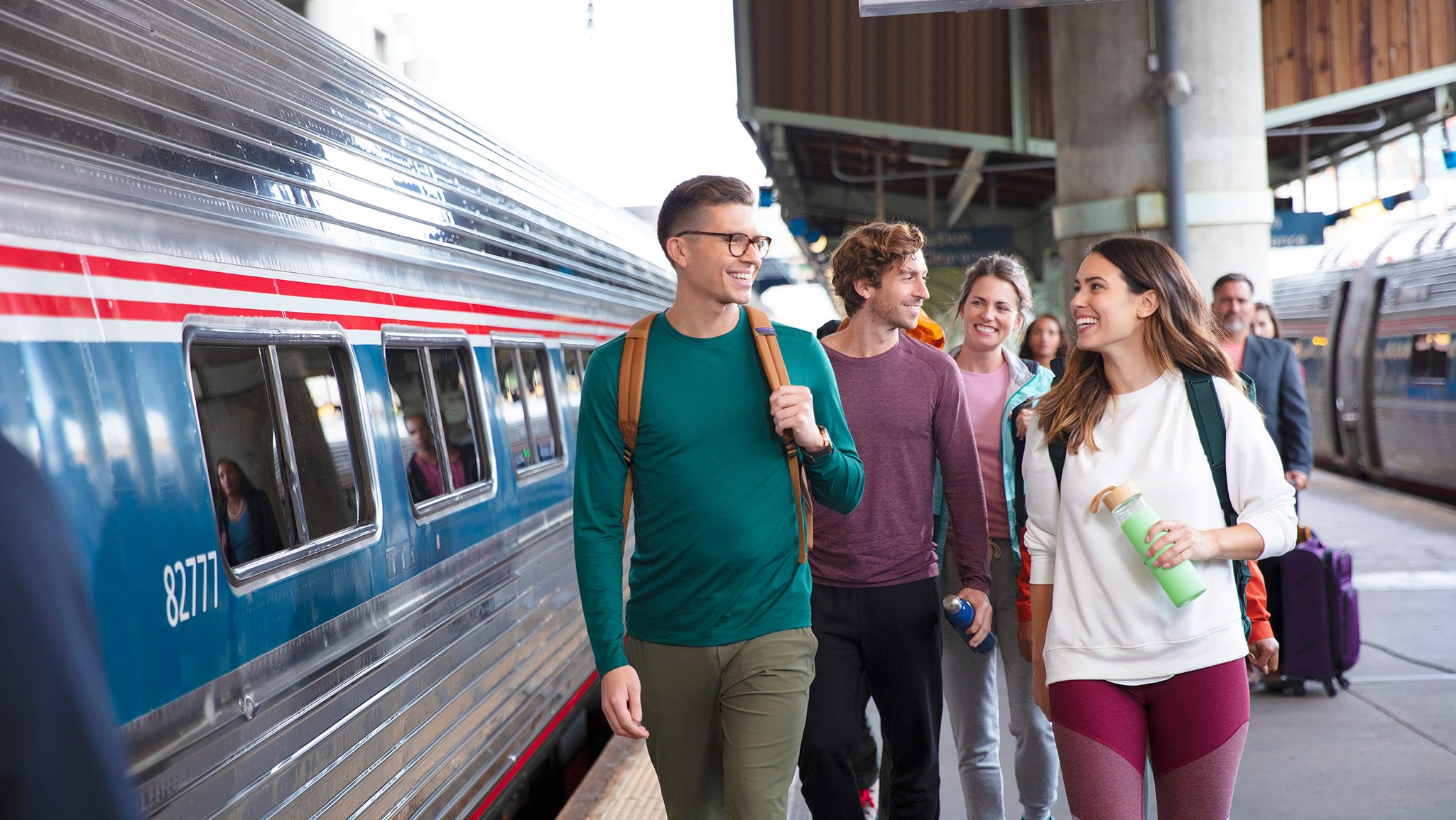 Friends on platform smiling and chatting