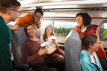 Friends onboard train chatting and laughing
