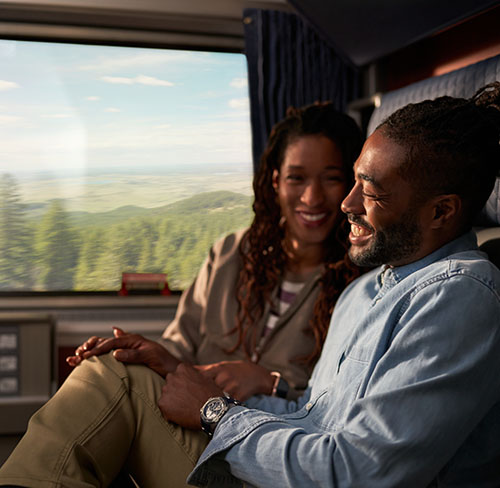 smiling-couple-seated-on-amtrak