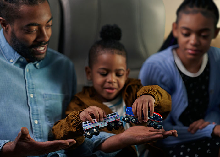 father-and-children-on-amtrak-with-toy-train