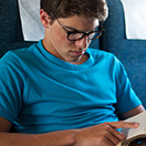 Student reading book onboard