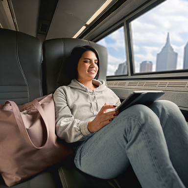 woman-seated-on-amtrak-using-her-ipad
