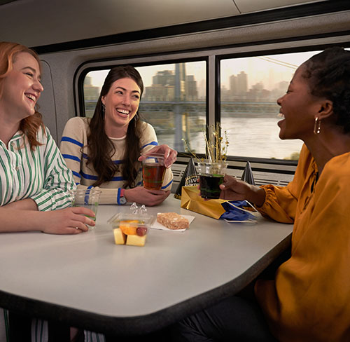 women-smiling-at-the-table-in-amtrak-cafe-car