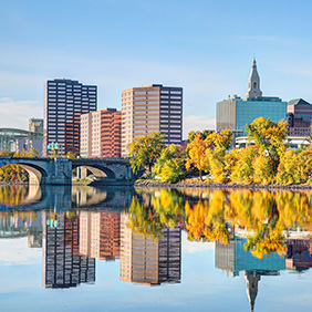 The Hartford Connecticut skyline is reflected in water