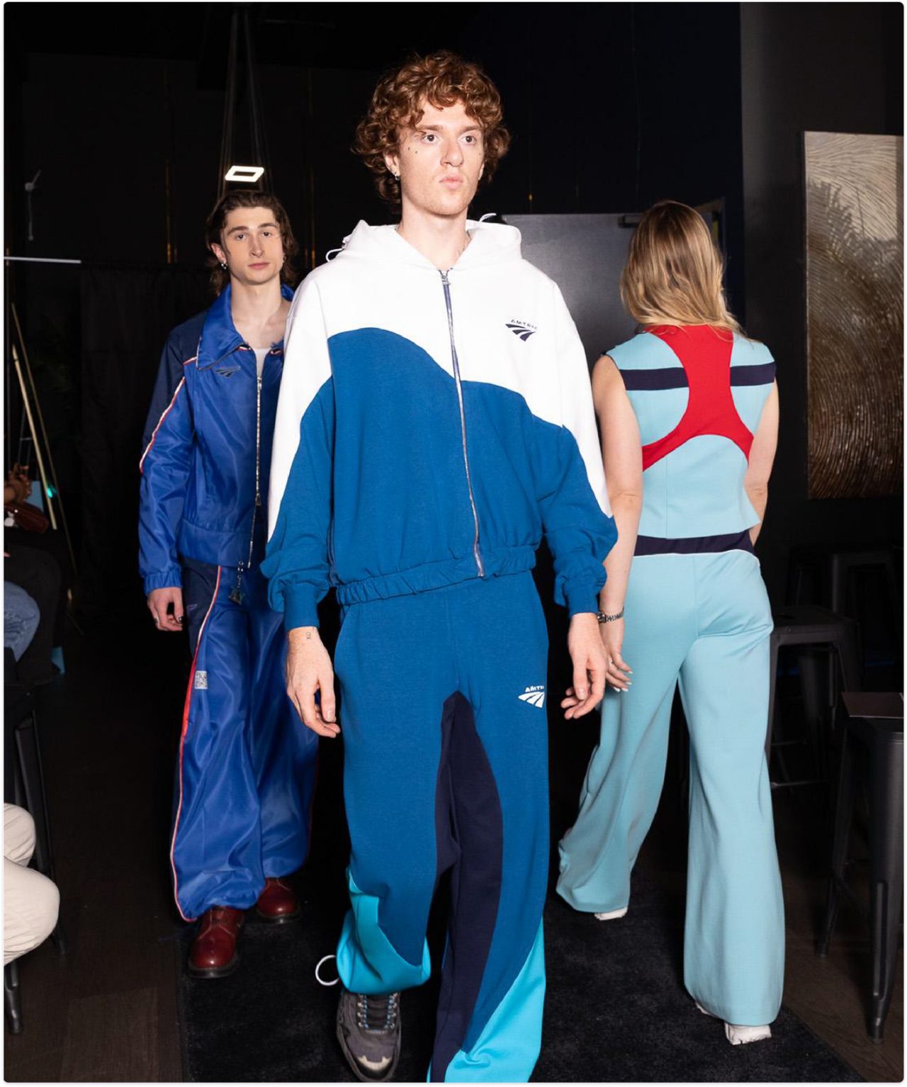 model walking down runway in amtrak traksuit